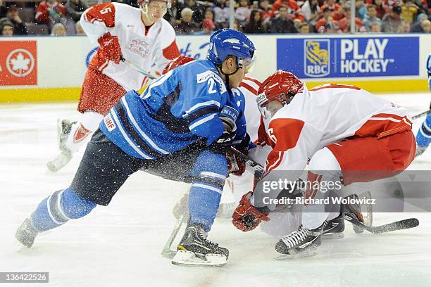 Mikael Granlund of Team Finland collides with Martin Rahbek of Team Denmark during the 2012 World Junior Hockey Championship game at Rexall Place on...