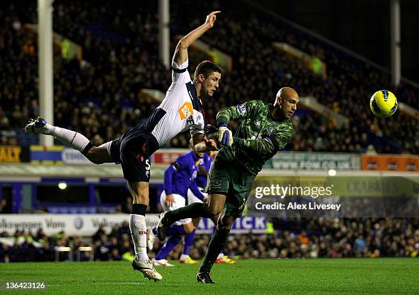 Gary Cahill of Bolton Wanderers competes with Tim Howard of Everton during the Barclays Premier League match between Everton and Bolton Wanderers at...