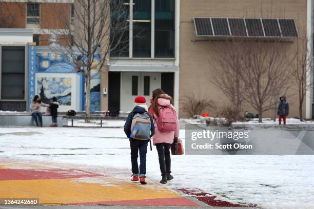 Students arrive for classes at A. N. Pritzker elementary school on January 12, 2022 in Chicago, Illinois. Students in Chicago public schools are...