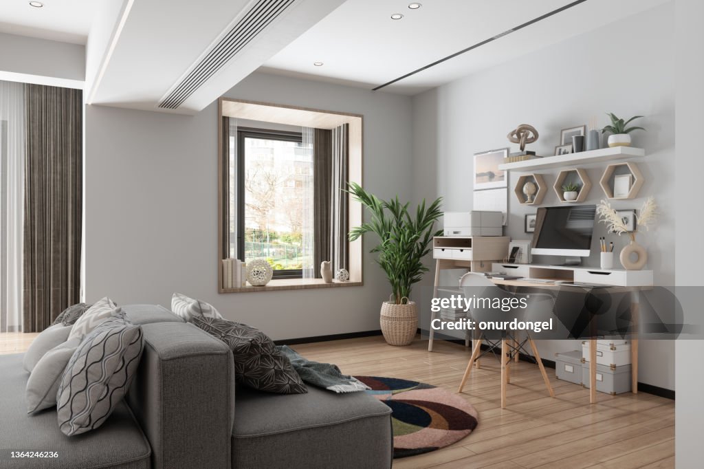 Working At Home. Home Office Interior With Wooden Table,
Blank Screen Monitor, Gray Color Sofa And Garden View From The Window.