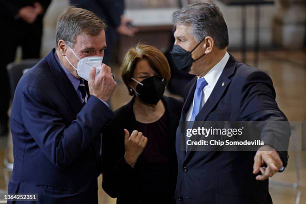 Sen. Mark Warner , Sen. Amy Klobuchar and Sen. Joe Manchin visit before the start of the memorial service for former Senate Majority Leader Harry...