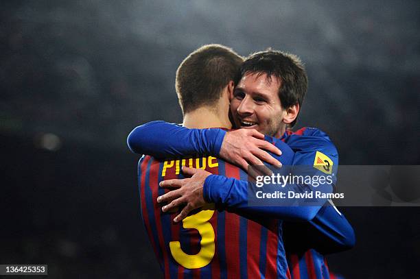 Lionel Messi of FC Barcelona celebrates with his teammate Gerard Pique of FC Barcelona after scoring his team's third goal during the round of last...