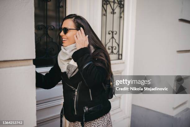 a woman talking on the intercom - audio intercom system stock pictures, royalty-free photos & images