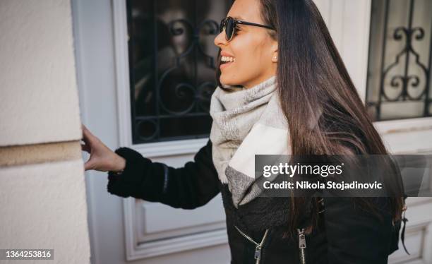 a woman talking on the intercom - audio intercom system stock pictures, royalty-free photos & images