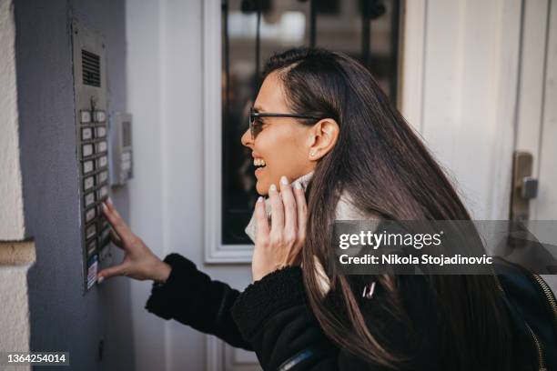 a woman talking on the intercom - intercom stock pictures, royalty-free photos & images