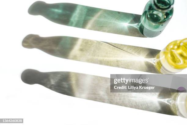 group of bottles with cosmetic liquids - bottle reflections stock pictures, royalty-free photos & images