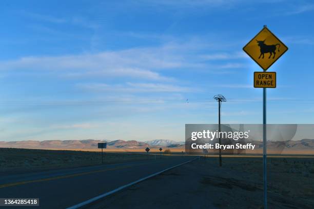 Signboard On Landscape Against Mountain Range Photos and Premium High ...