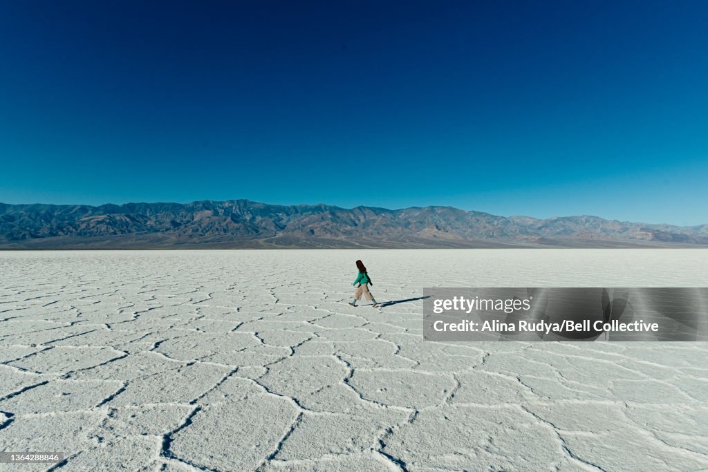 Woman walking on a salt flat