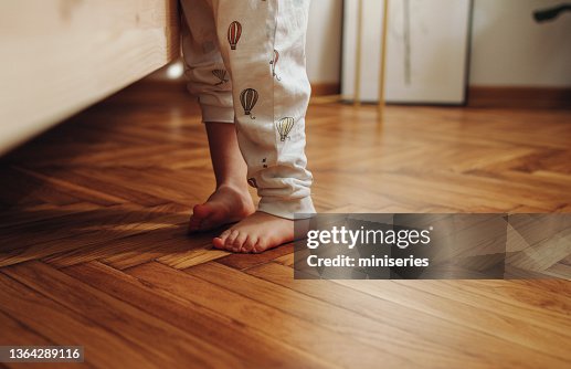 Close Up Shot of Child's Legs on the Wooden Floor Close Up Shot of Child's Legs on the Wooden Floor