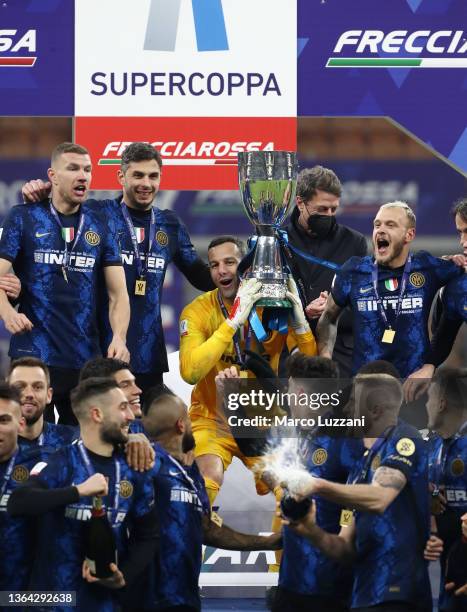 Samir Handanovic of Inter Milan lifts the Italian Supercup trophy following victory in the Italian Supercup match between Inter and Juventus at The...