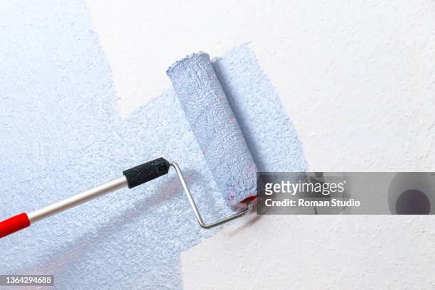 roller brush painting - interior finishing stock pictures, royalty-free photos & images