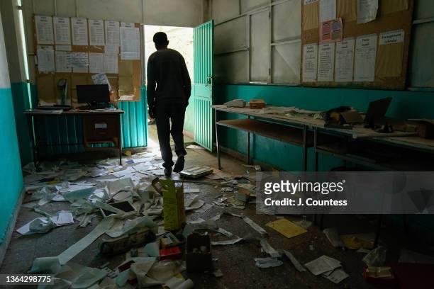 Solomon Terefe walks through debris that litters the floor of the medical lab at the Mersa Health Center in North Wollo on January 12, 2022 in Mersa,...