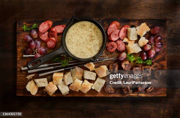 cheese fondue platter with grilled steak bites - cheese fondue stock pictures, royalty-free photos & images