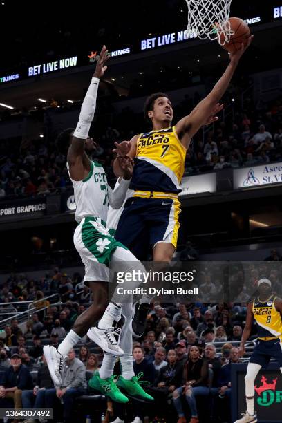 Malcolm Brogdon of the Indiana Pacers attempts a shot while being guarded by Dennis Schroder of the Boston Celtics in the second quarter at...