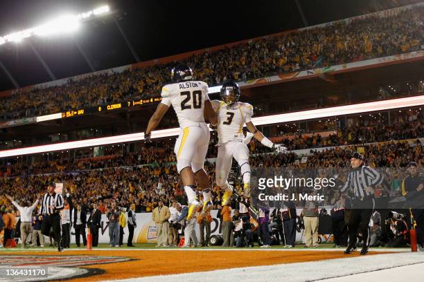 Shawne Alston and Stedman Bailey of the West Virginia Mountaineers celebrate after Alston rushds for a 4-yard touchdown in the first quarter against...