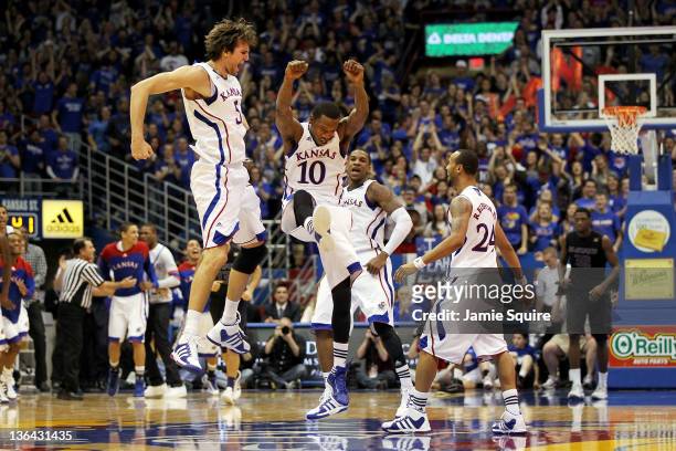 Jeff Withey, Tyshawn Taylor, Thomas Robinson and Travis Rutherford of the Kansas Jayhawks celebrate after scoring during the game against the Kansas...