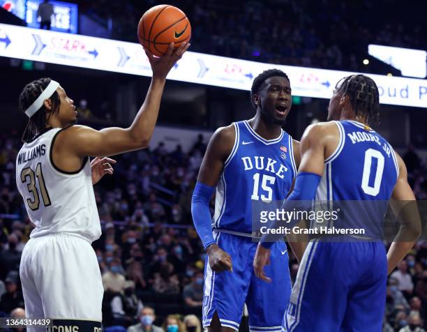 Mark Williams reacts as teammate Wendell Moore Jr. #0 of the Duke Blue Devils scores and draws a foul against Alondes Williams of the Wake Forest...