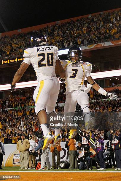 Shawne Alston and Stedman Bailey of the West Virginia Mountaineers celebrate after Alston rushds for a 4-yard touchdown in the first quarter against...