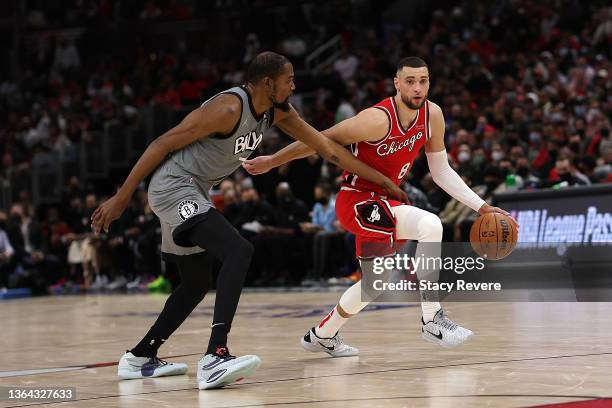 Zach LaVine of the Chicago Bulls drives around Kevin Durant of the Brooklyn Nets during the first half of a game at United Center on January 12, 2022...