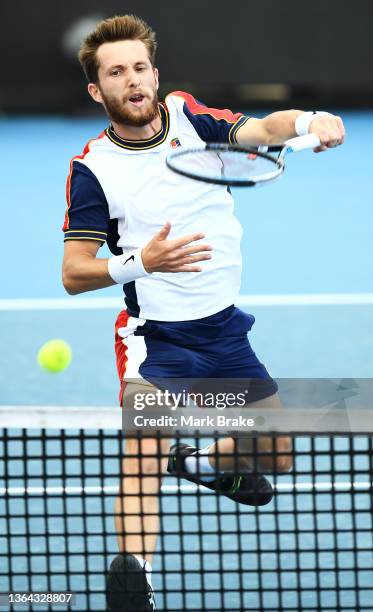 Corentin Moutet of France hits an overhead forehand in his match against Thiago Monteiro of Brazil during day five of the 2022 Adelaide International...