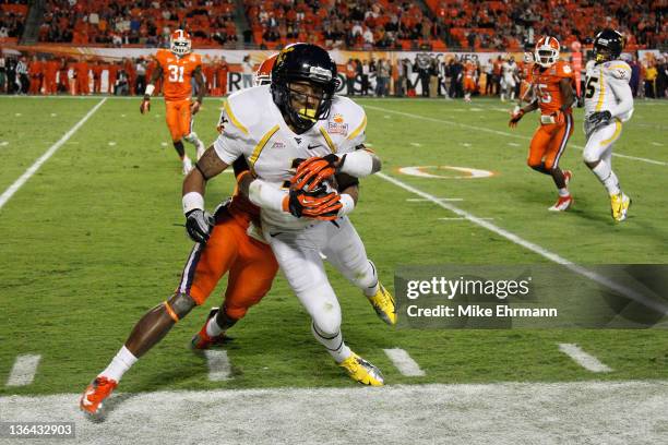 Stedman Bailey of the West Virginia Mountaineers makes a reception in the third quarter against Stephone Anthony of the Clemson Tigers during the...