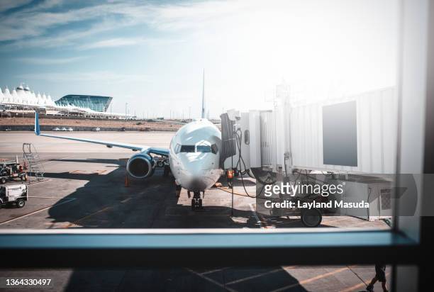 plane at denver airport - airport tarmac stock pictures, royalty-free photos & images