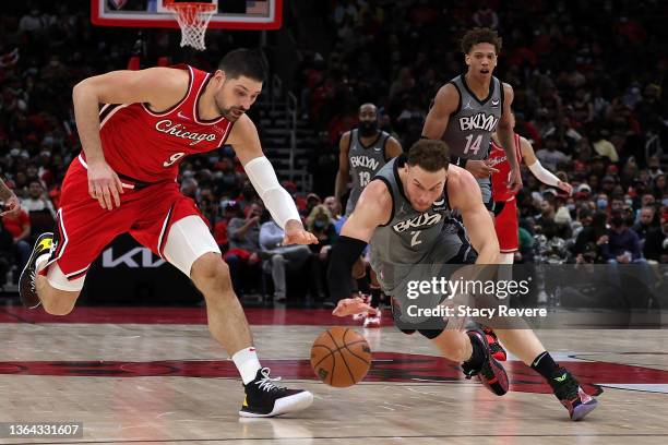 Blake Griffin of the Brooklyn Nets dives for a loose ball against Nikola Vucevic of the Chicago Bulls during the second half of a game at United...
