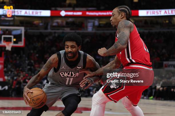 Kyrie Irving of the Brooklyn Nets drives to the basket against DeMar DeRozan of the Chicago Bulls during the second half of a game at United Center...