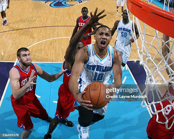 Eric Gordon of the New Orleans Hornets goes to the basket under pressure during an NBA game between the Philadelphia 76ers and the New Orleans...