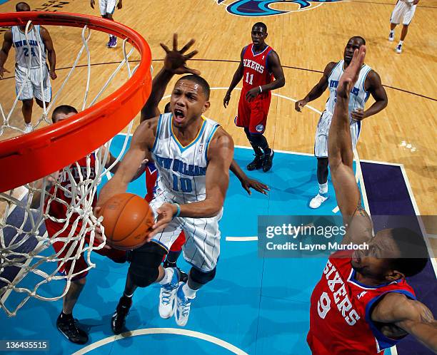 Eric Gordon of the New Orleans Hornets goes to the basket under pressure during an NBA game between the Philadelphia 76ers and the New Orleans...