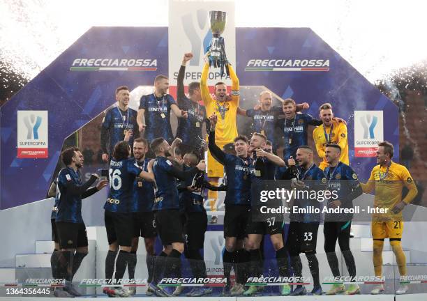 Samir Handanovic of FC Internazionale lifts the SuperCup Trophy as his teammates celebrate after the the italian SuperCup match between FC...
