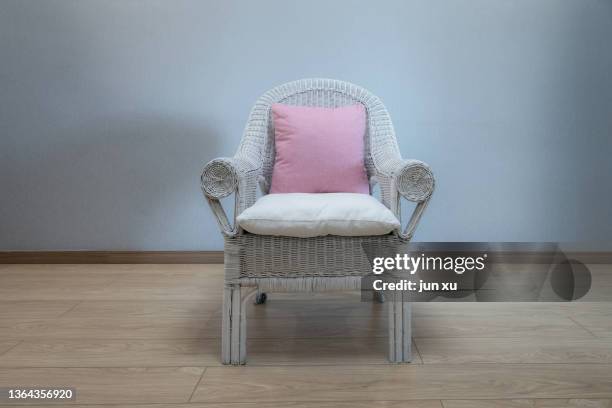 red cushions on a white cane chair - comfort zone stock pictures, royalty-free photos & images