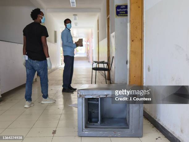 Looted safe can be seen in the foreground as Doctors Getachew Mola and Meheret Mekuria lead journalist through the facilities at the Mersa Metro...
