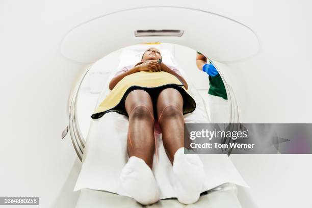 view of patient's legs inside a ct scanner - cat scan machine stock pictures, royalty-free photos & images