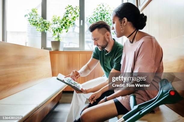 nurse going over ct scans with patient in waiting room - all access imagens e fotografias de stock