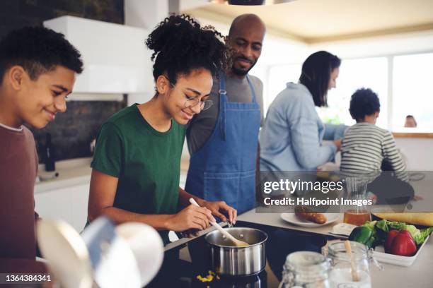 happy multiracial family with three children cooking together at home. - kitchen cooking stockfoto's en -beelden