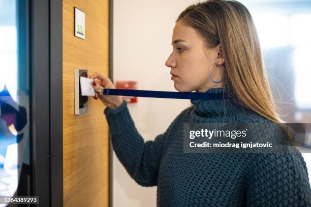 caucasian female staff using id enter key to open the door at the building - rfid technology stock pictures, royalty-free photos & images