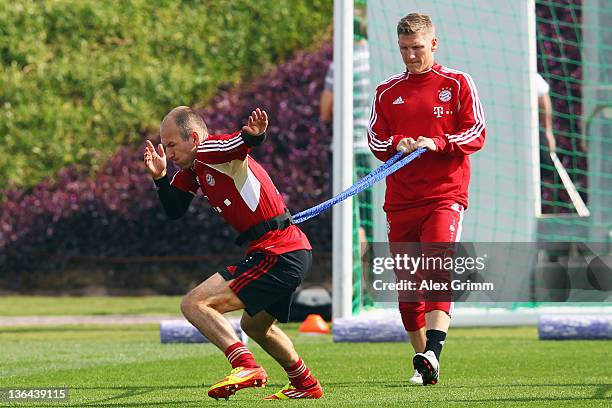 Arjen Robben and Bastian Schweinsteiger exercise during a training session of Bayern Muenchen at the ASPIRE Academy for Sports Excellence on January...