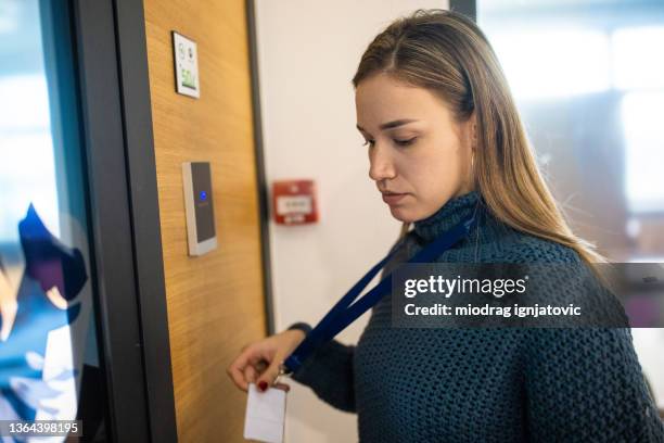 female staff using id enter key to open the door at the building - keycard access bildbanksfoton och bilder