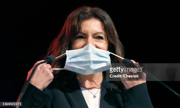Mayor of Paris and Socialist Party party candidate for the 2022 French presidential election Anne Hidalgo takes off her protective face mask prior to...