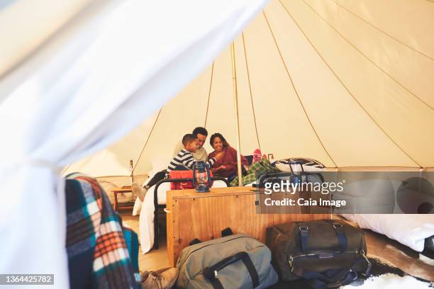 family relaxing on bed inside camping yurt - luxury tent stock pictures, royalty-free photos & images
