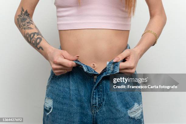 woman losing weight - slim skinny stock-fotos und bilder