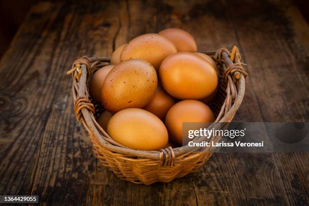 organic eggs in a basket - eggs basket stock pictures, royalty-free photos & images
