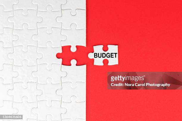budget cut text on jigsaw puzzle - budget cut - budget cuts stock-fotos und bilder