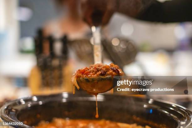 generation z multiracial group of friends cooking and eating chili playing relaxing and communicating in modern home photo series - chili con carne stockfoto's en -beelden