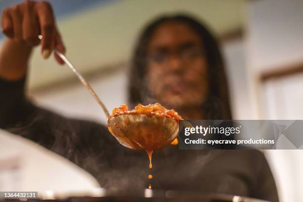 generation z multiracial group of friends cooking and eating chili playing relaxing and communicating in modern home photo series - female eating chili bildbanksfoton och bilder