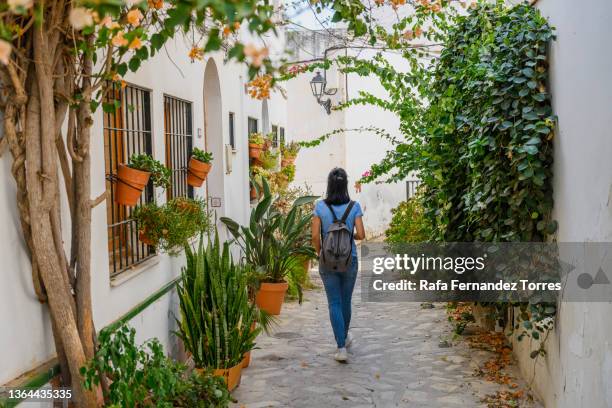 young tourist female discovering old town streets of salobreña, spain - granada stockfoto's en -beelden