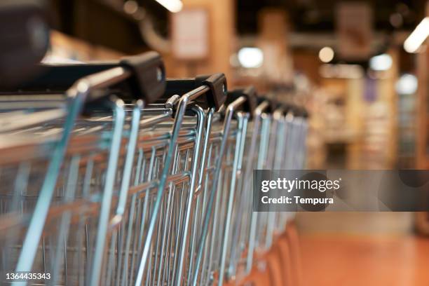 supermarket shopping carts in a row. - shopping cart stock pictures, royalty-free photos & images