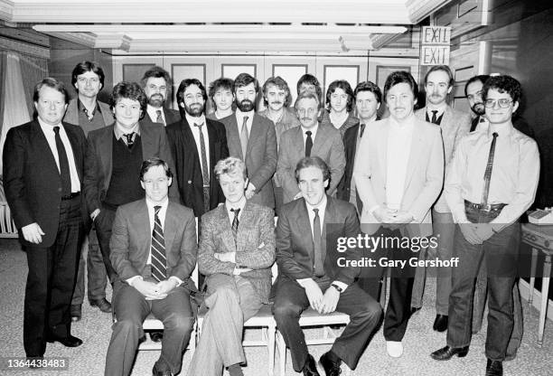 Portrait of British Rock musician David Bowie , with various, unidentified EMI record executives, at the Carlyle Hotel, New York, New York, January...