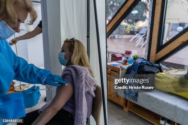 Nurse Tinka Bacheva, administers a COVID-19 vaccination at Bar for health on January 13, 2022 in Sofia, Bulgaria. Bar for health is a place where...